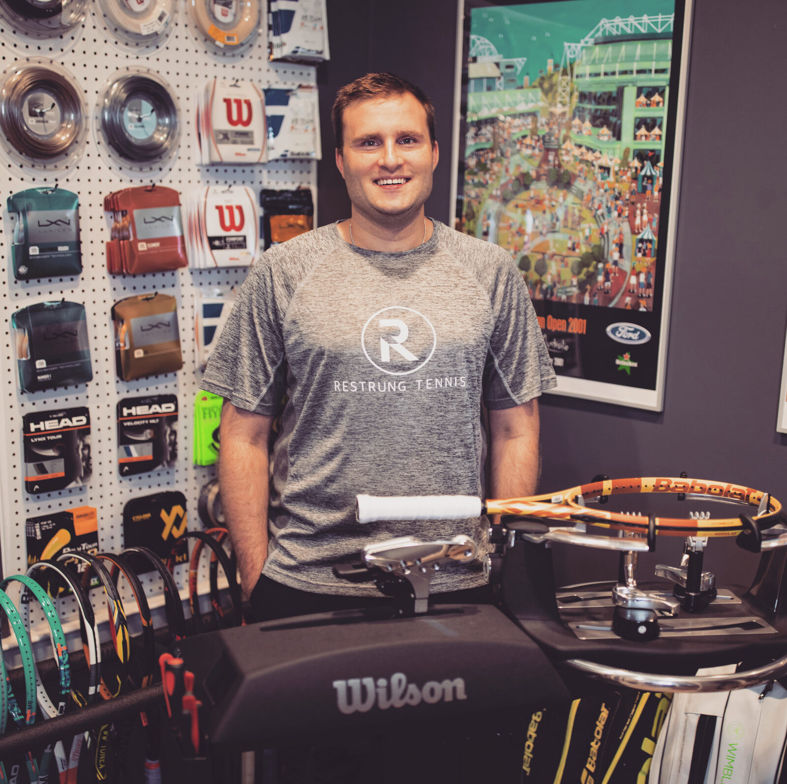 Restrung Tennis founder at stringing station